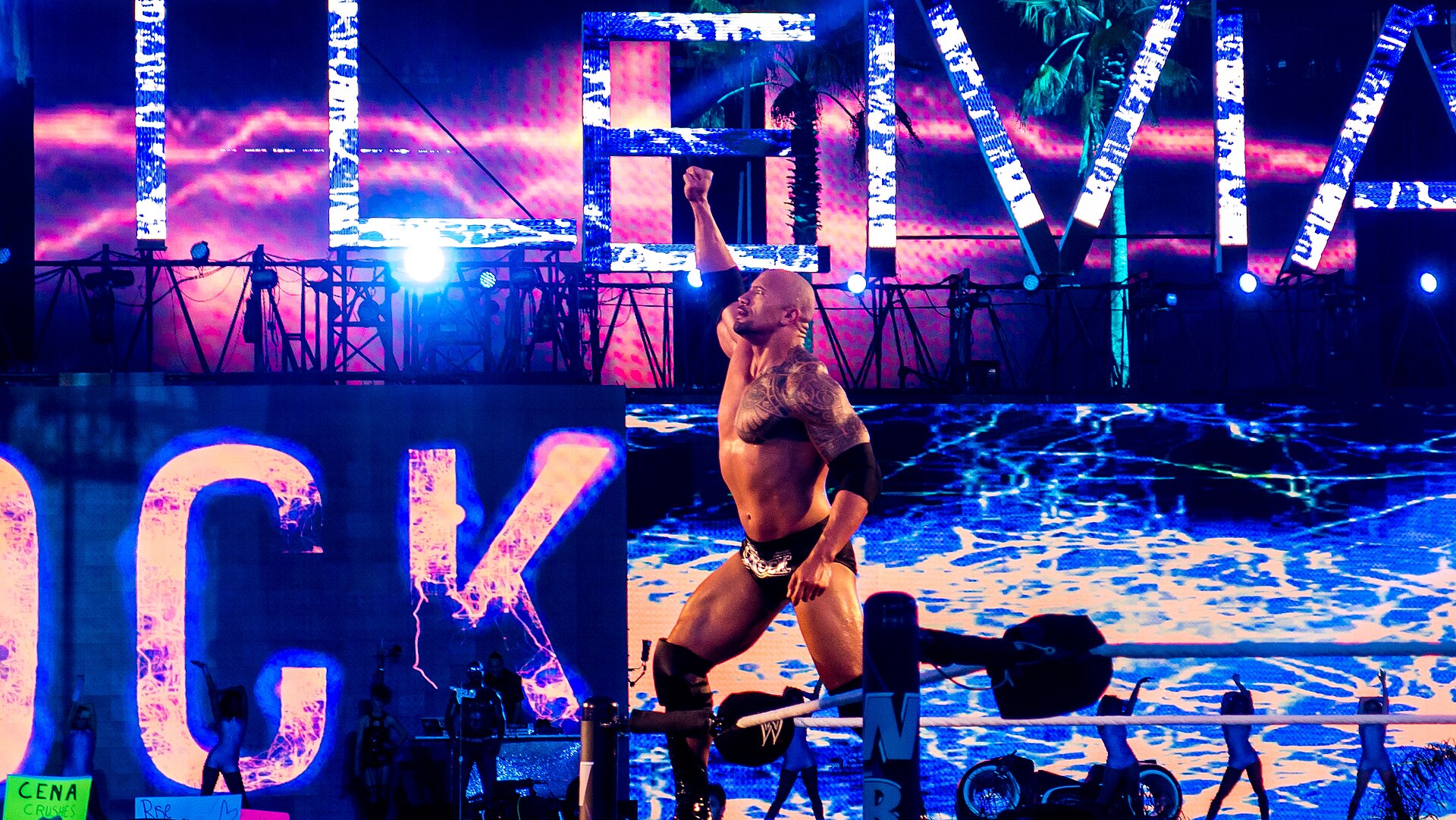 Dwayne Johnson raises his fist in the ring at WrestleMania XXVIII